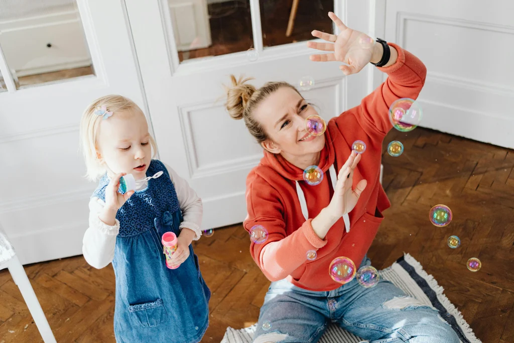 10 Fun Learning Activities for Toddlers That Boost Brain Development 8 mama and baby blowing bubbles