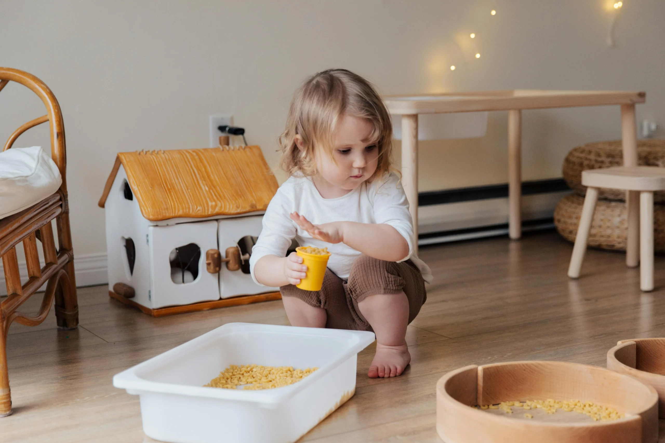 toddler playing with sensory bin