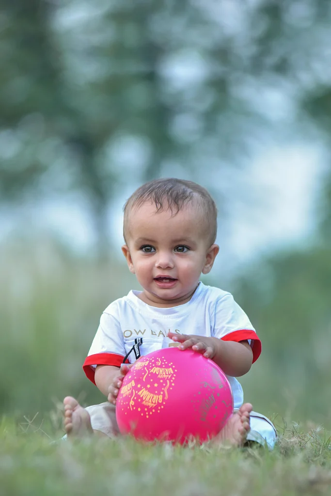 25 Engaging Tummy Time Ideas to Help Your Baby Grow Strong 17 soft ball rolling game for baby